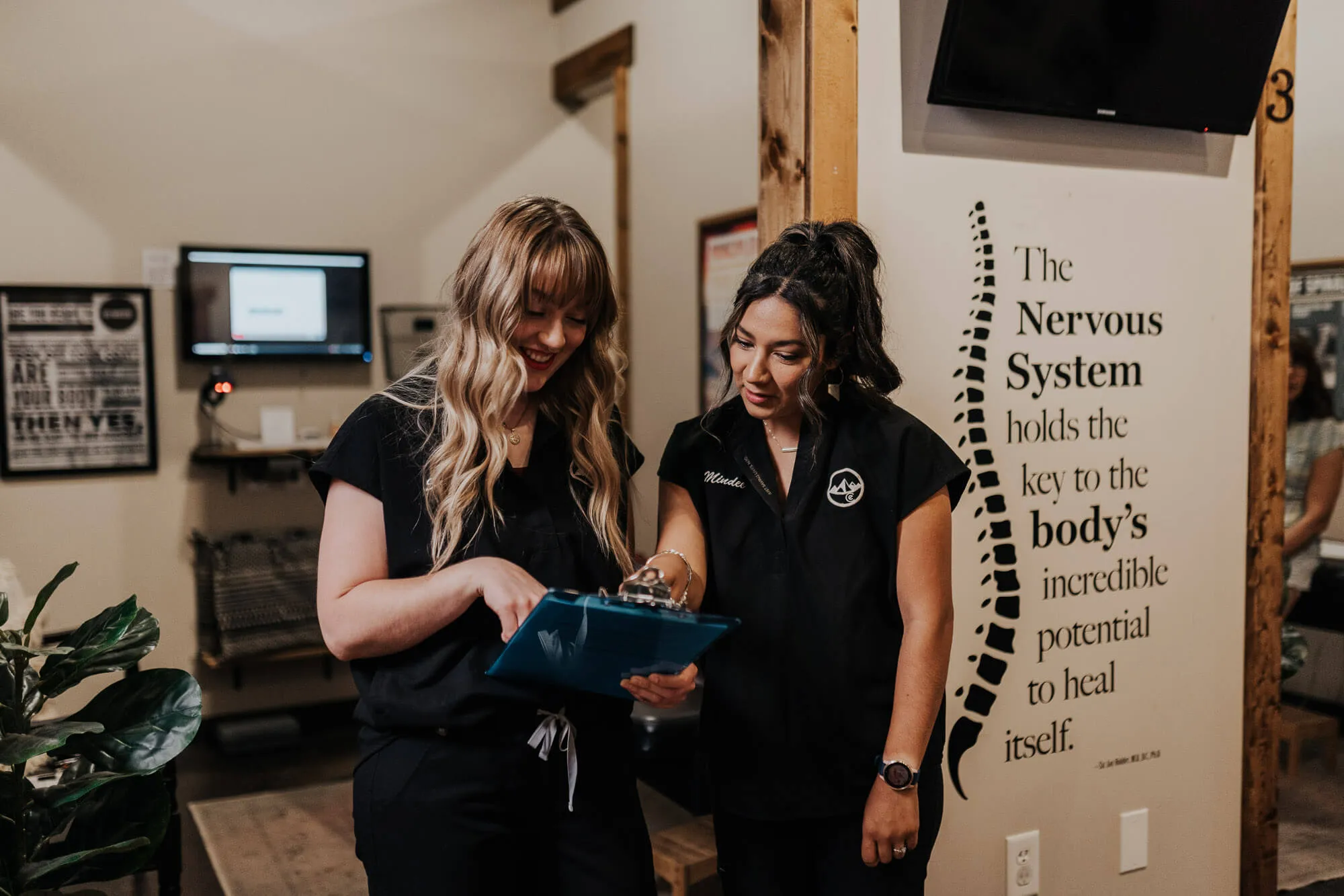 Chiropractors looking at a clipboard