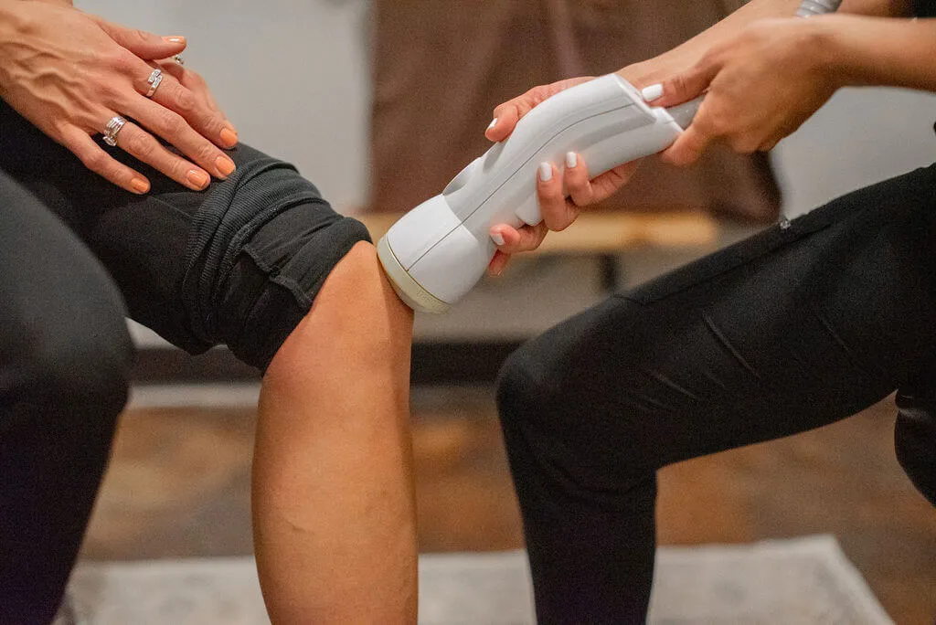 SoftWave treatment on a patient's knee